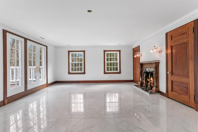 unfurnished living room with ornamental molding, baseboards, and a premium fireplace