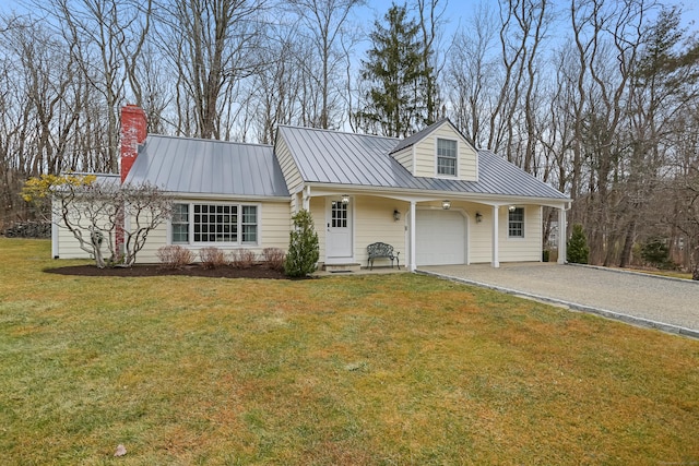 view of front facade featuring driveway, a standing seam roof, an attached garage, a front lawn, and metal roof