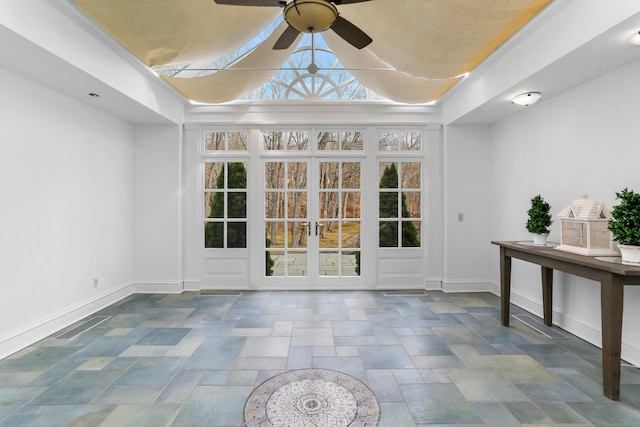 interior space with lofted ceiling, visible vents, and ceiling fan