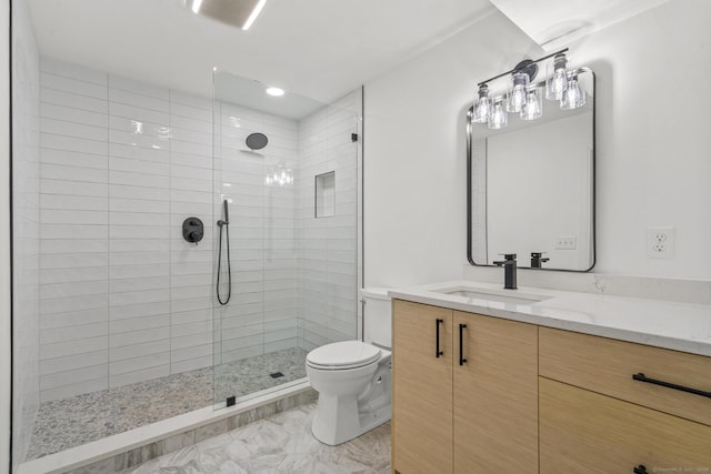 full bath with marble finish floor, a tile shower, vanity, and toilet