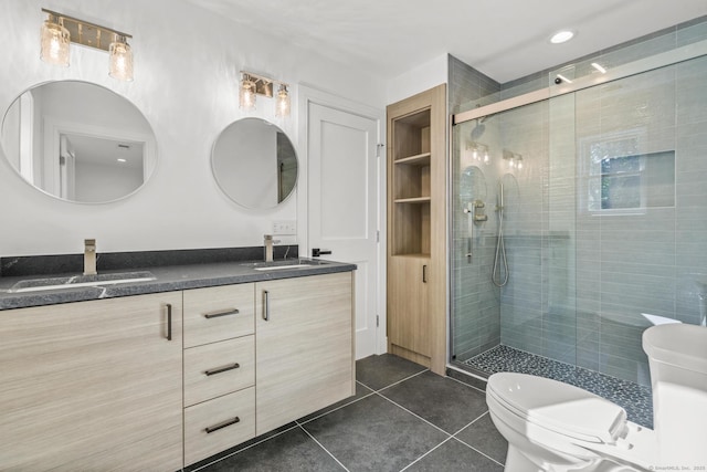 bathroom with a stall shower, tile patterned flooring, a sink, and toilet