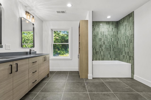 bathroom with double vanity, baseboards, visible vents, tile patterned flooring, and a sink