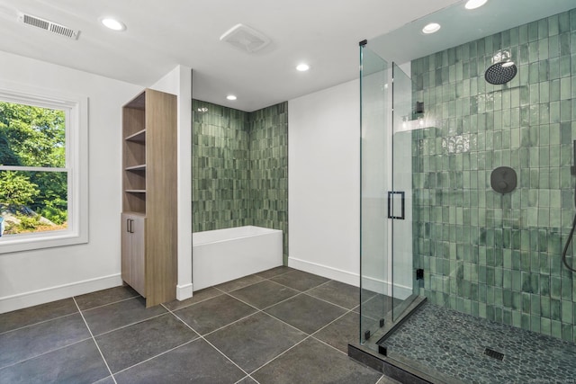 full bathroom featuring visible vents, baseboards, tile patterned floors, a washtub, and a shower stall