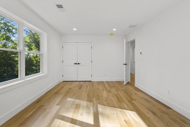 unfurnished bedroom with light wood-style floors, visible vents, baseboards, and recessed lighting