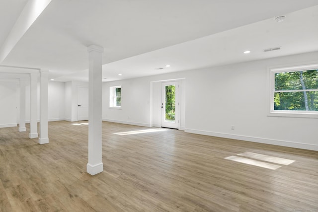 basement with light wood-type flooring, visible vents, plenty of natural light, and recessed lighting