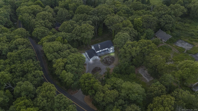 birds eye view of property with a view of trees