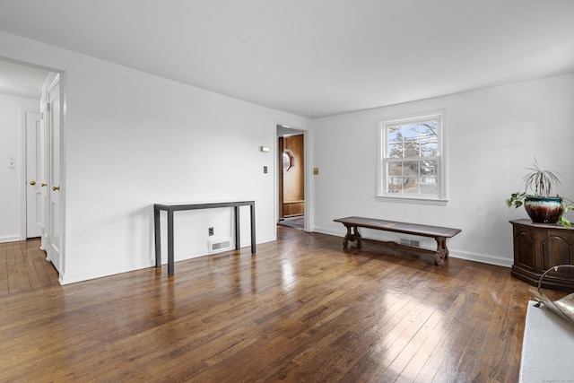 empty room featuring hardwood / wood-style flooring, baseboards, and visible vents