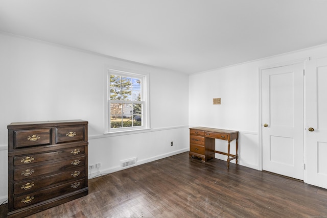 bedroom with wood finished floors, visible vents, and baseboards