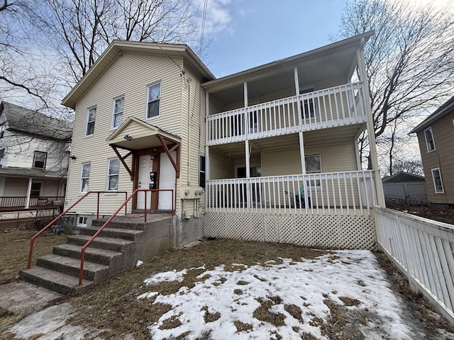 view of front of house featuring a balcony and covered porch