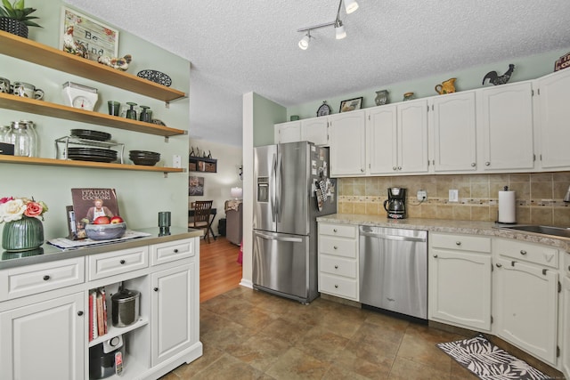 kitchen with open shelves, tasteful backsplash, and stainless steel appliances