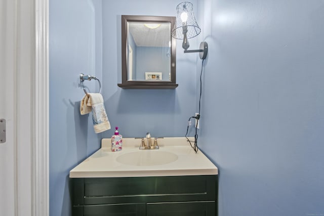 bathroom with a textured ceiling and vanity