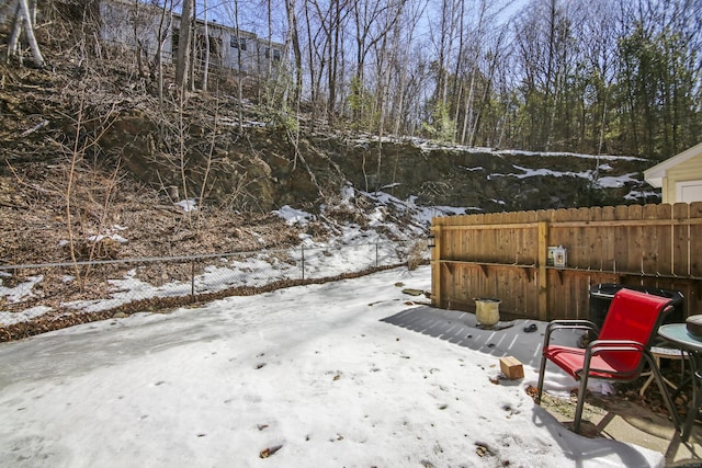 yard covered in snow with fence