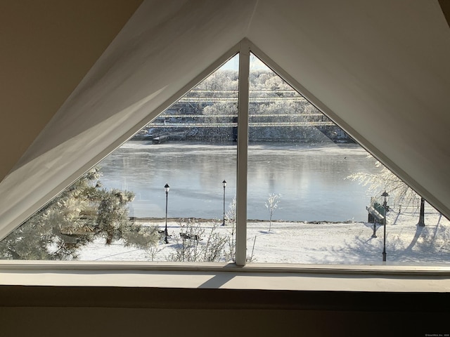 interior space with plenty of natural light and a water view