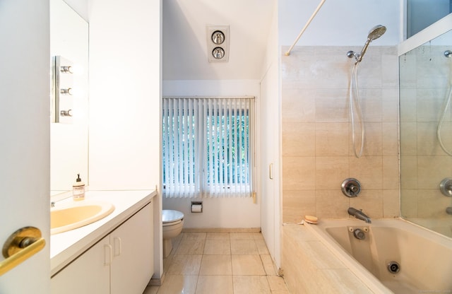 bathroom featuring tile patterned floors, shower / bathtub combination, toilet, and vanity