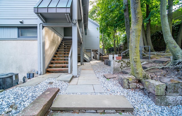 exterior space featuring cooling unit and a standing seam roof