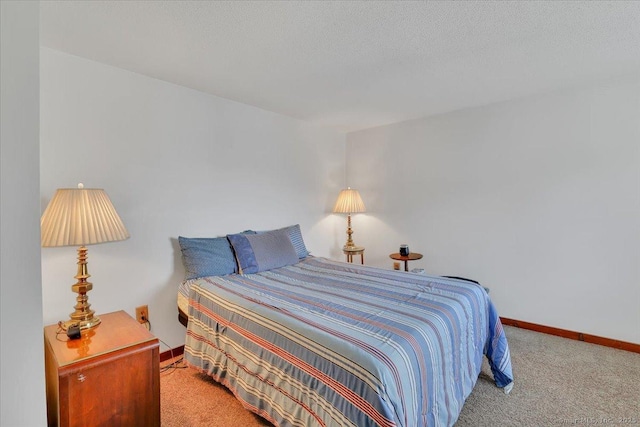 bedroom with carpet flooring, a textured ceiling, and baseboards