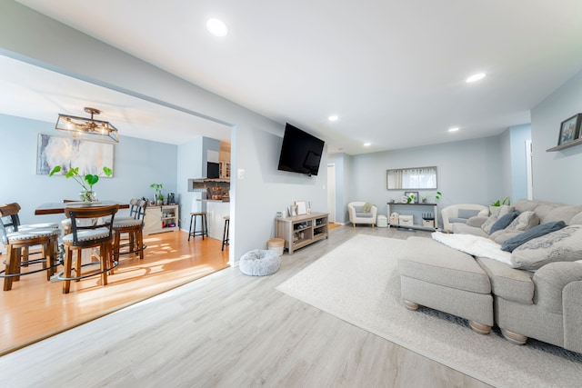 living area featuring wood finished floors and recessed lighting