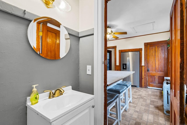 bathroom featuring brick floor, ceiling fan, and vanity