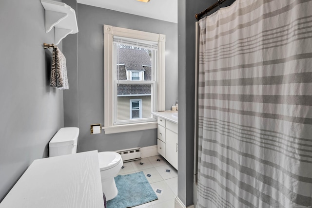 full bath featuring toilet, baseboard heating, vanity, baseboards, and tile patterned floors