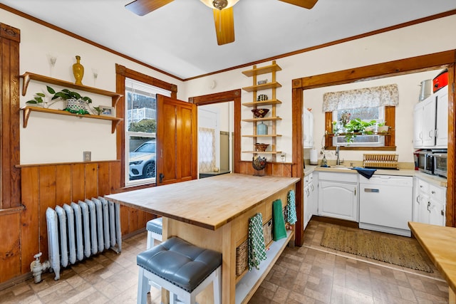 kitchen with open shelves, radiator heating unit, white cabinetry, a sink, and dishwasher