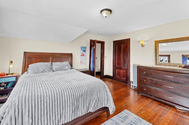 bedroom featuring hardwood / wood-style flooring and baseboards