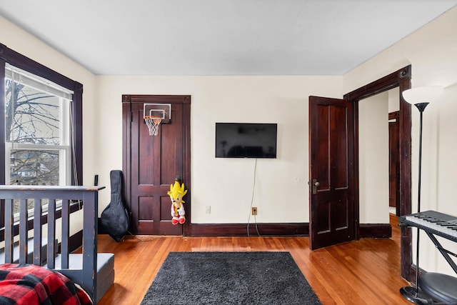 bedroom featuring baseboards and wood finished floors