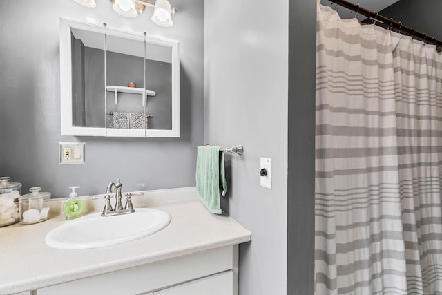 bathroom with curtained shower and vanity