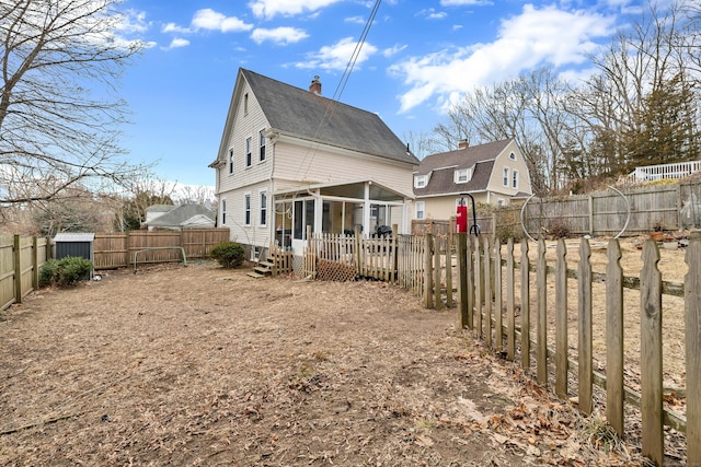 rear view of property with a sunroom and a fenced backyard