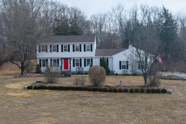 colonial-style house with a front yard