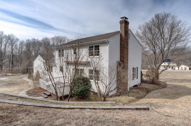 view of side of home with a chimney