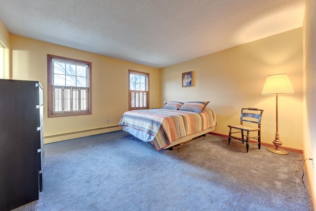 bedroom with a baseboard heating unit, carpet floors, a textured ceiling, and baseboards