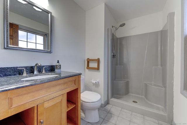 bathroom with vanity, tile patterned flooring, walk in shower, and toilet