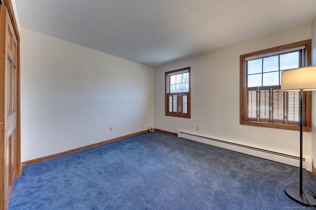 unfurnished room featuring carpet, a baseboard radiator, baseboards, and a textured ceiling