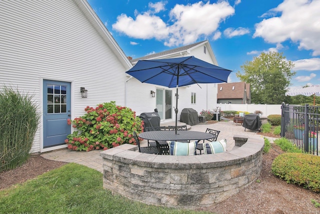 view of patio featuring fence and area for grilling