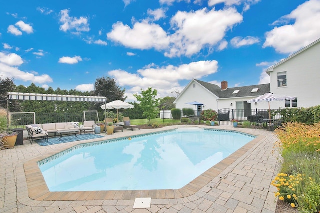 view of swimming pool featuring fence, an outdoor hangout area, a fenced in pool, and a patio