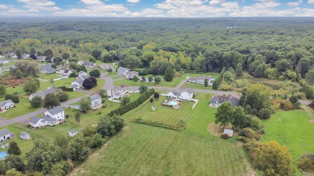 drone / aerial view with a residential view and a view of trees