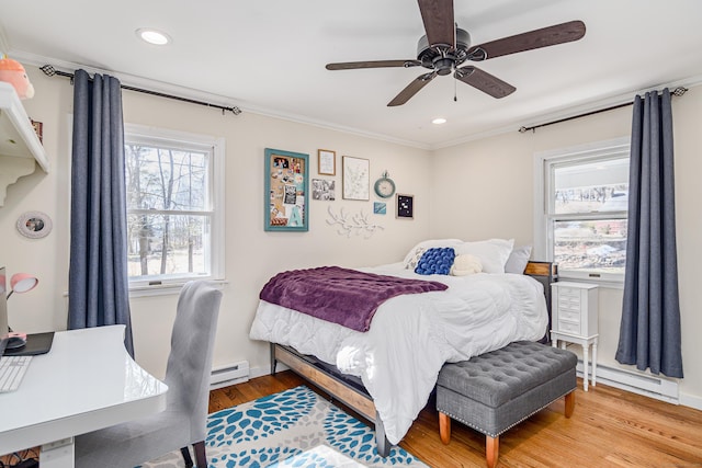 bedroom featuring ornamental molding, a baseboard radiator, recessed lighting, and wood finished floors