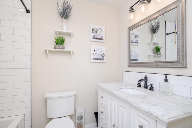 bathroom with toilet, visible vents, and vanity