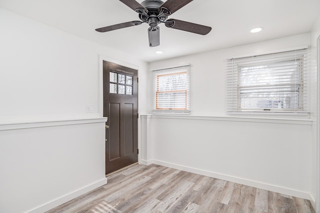 foyer with light wood-type flooring, baseboards, and recessed lighting