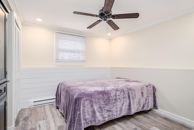 bedroom featuring a ceiling fan, ornamental molding, wood finished floors, a baseboard heating unit, and recessed lighting