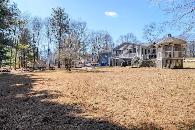 back of property with stairs and a wooden deck