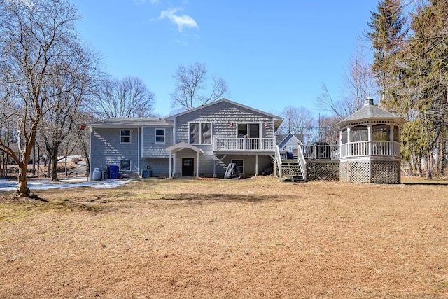 rear view of house with stairs, a yard, central AC, and a wooden deck