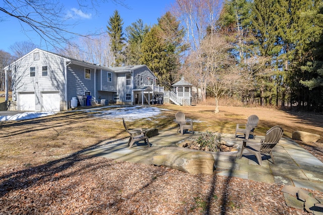 view of front of home featuring an outdoor fire pit, a patio, and stairway