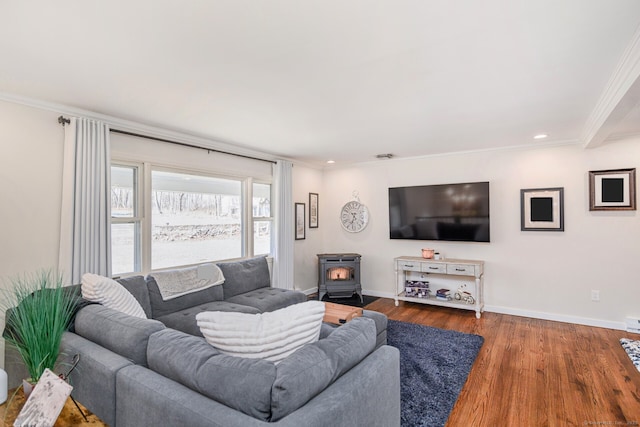 living area with ornamental molding, baseboards, and wood finished floors