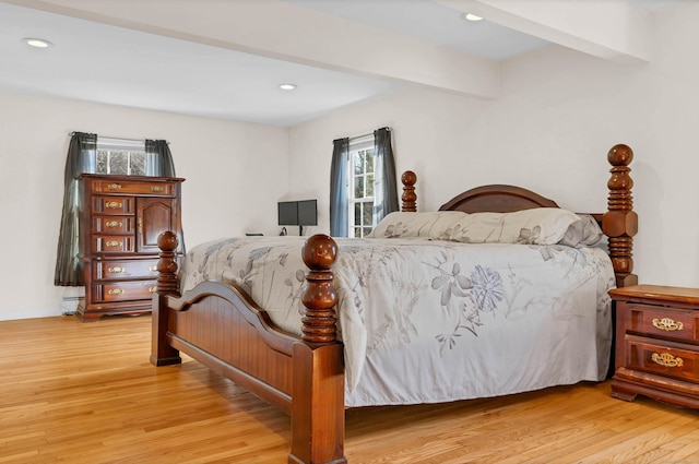 bedroom with light wood-style flooring, beamed ceiling, and recessed lighting