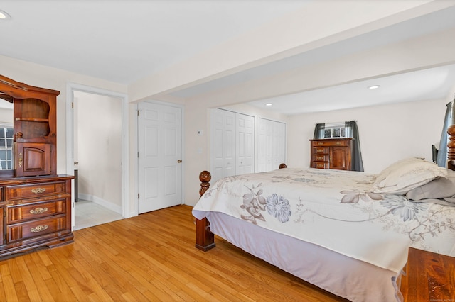 bedroom with light wood-style floors, a closet, and recessed lighting