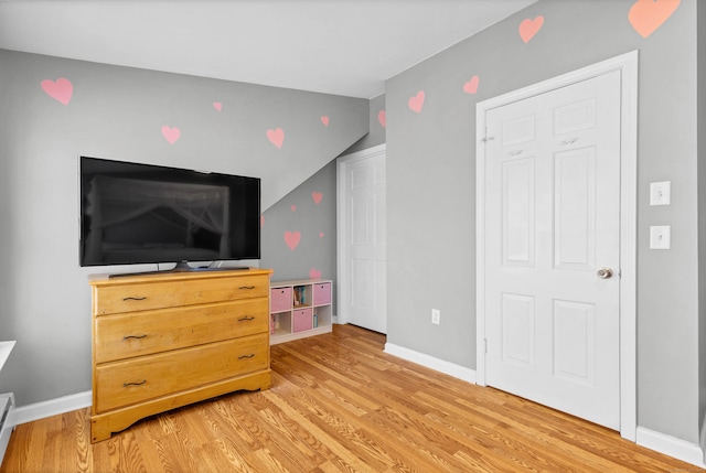 bedroom featuring light wood-style floors and baseboards