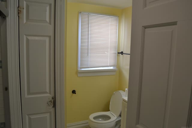 bathroom featuring toilet and baseboards