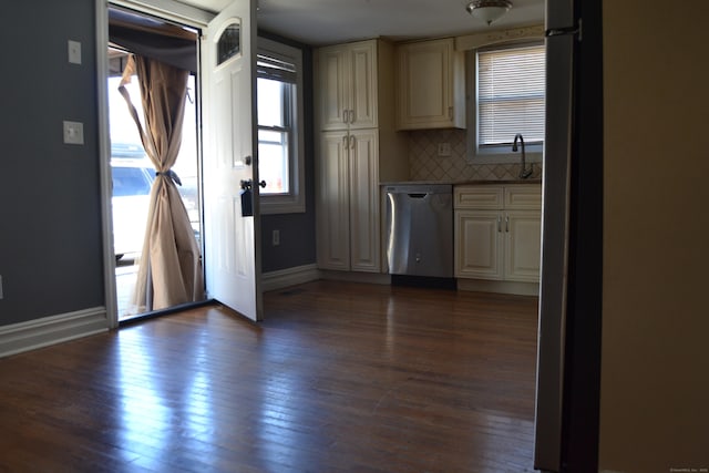 kitchen featuring tasteful backsplash, baseboards, dark wood-style flooring, stainless steel dishwasher, and a sink