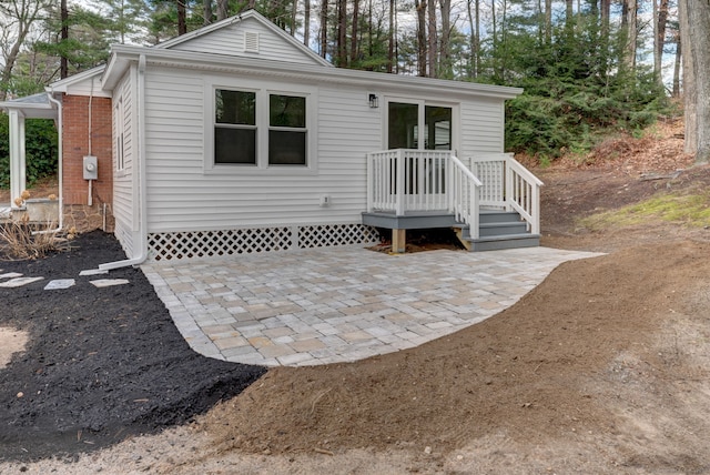 view of front of house with a patio area and brick siding